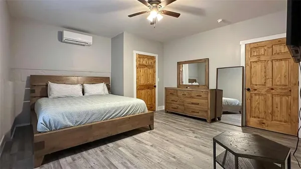 a bedroom with a bed and wooden floor