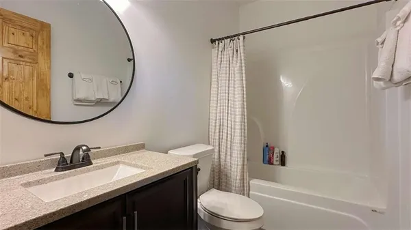 a bathroom with a sink a toilet and a mirror