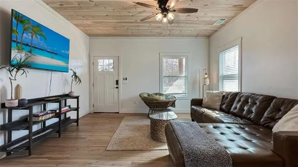 a living room with furniture and a flat screen tv