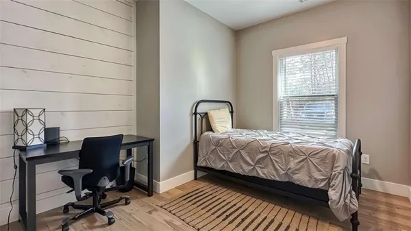 a bedroom with a bed chair and a window