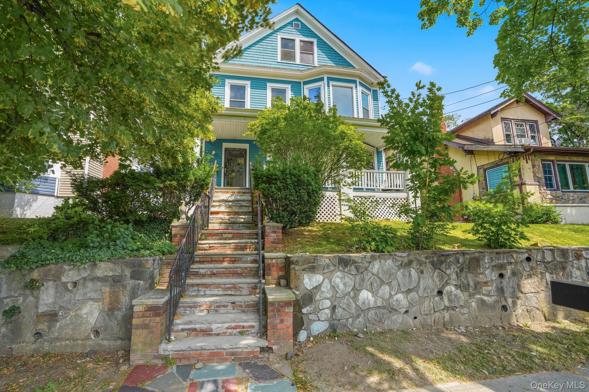 65 North Clinton Street Poughkeepsie, NY 12601 - Photo 2 of 43 a front view of a house with a yard