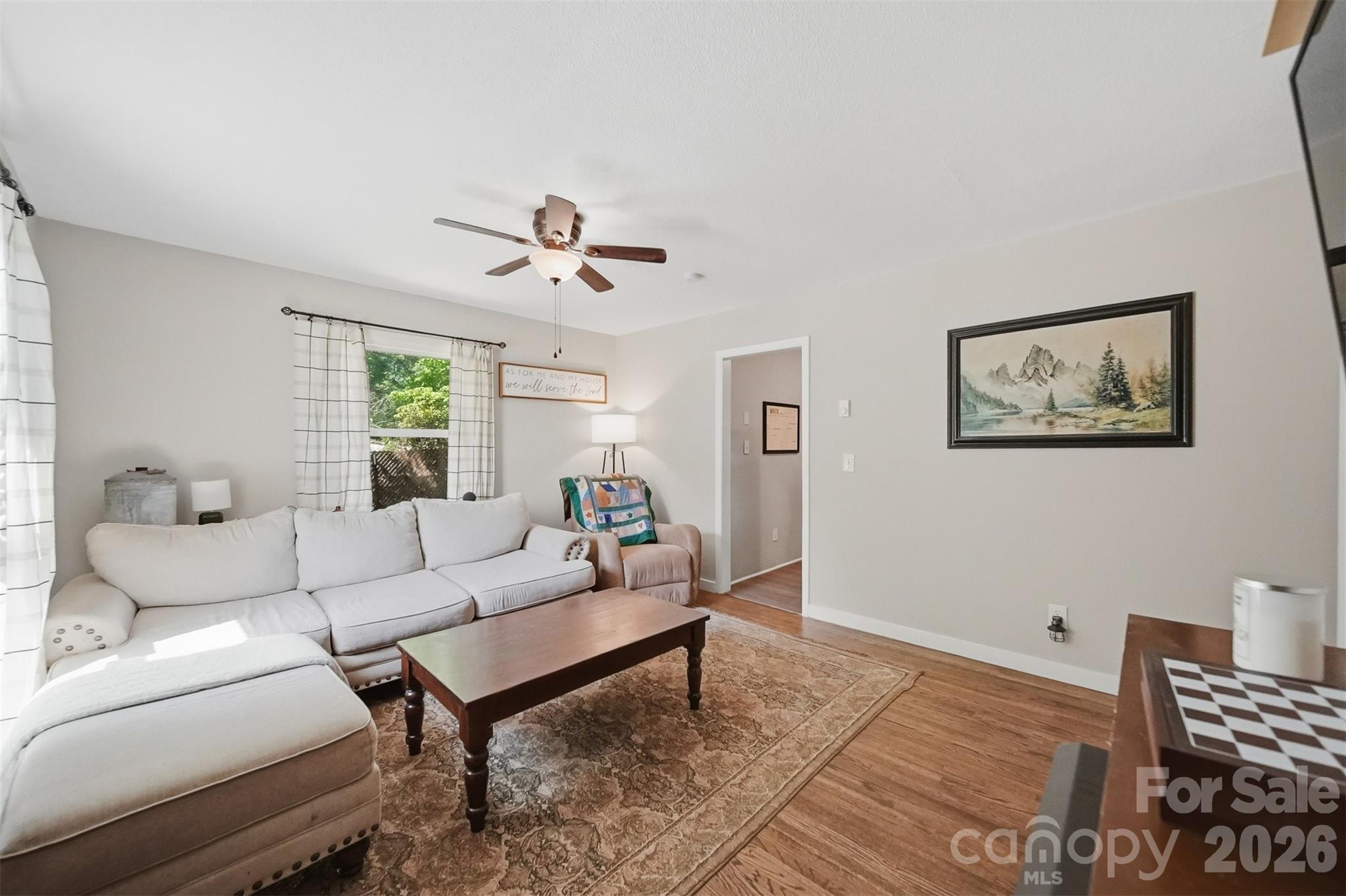 1312 County Home Road Conover, NC 28613 - Photo 5 of 25 a living room with furniture a ceiling fan and a window