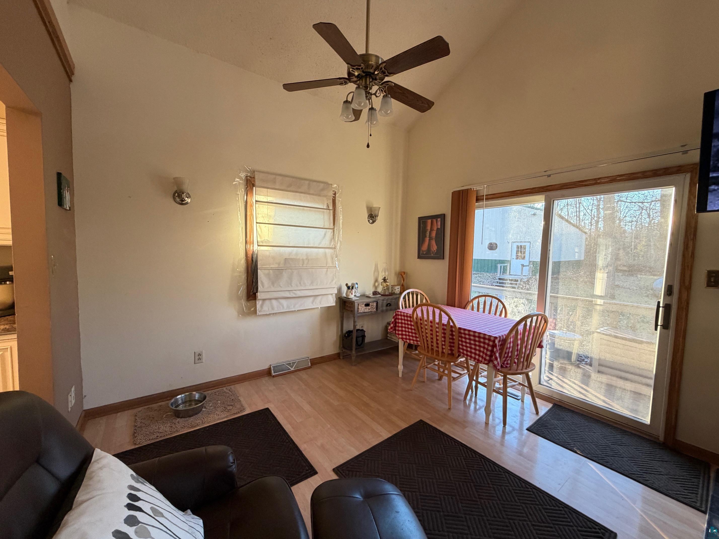 777 Harlis Road Holyoke, MN 55749 - Photo 4 of 22 Living area featuring high vaulted ceiling, plenty of natural light, ceiling fan, and light wood-style floors