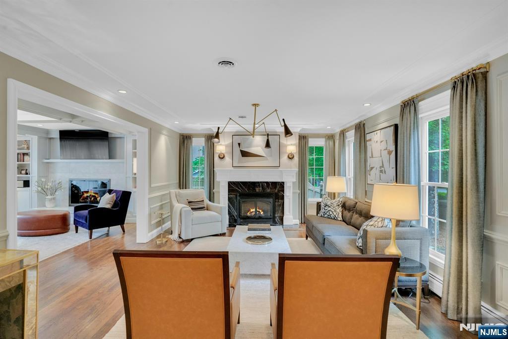 48 Hopper Farm Road Upper Saddle River, NJ 07458 - Photo 7 of 43 a living room with furniture a fireplace and a flat screen tv