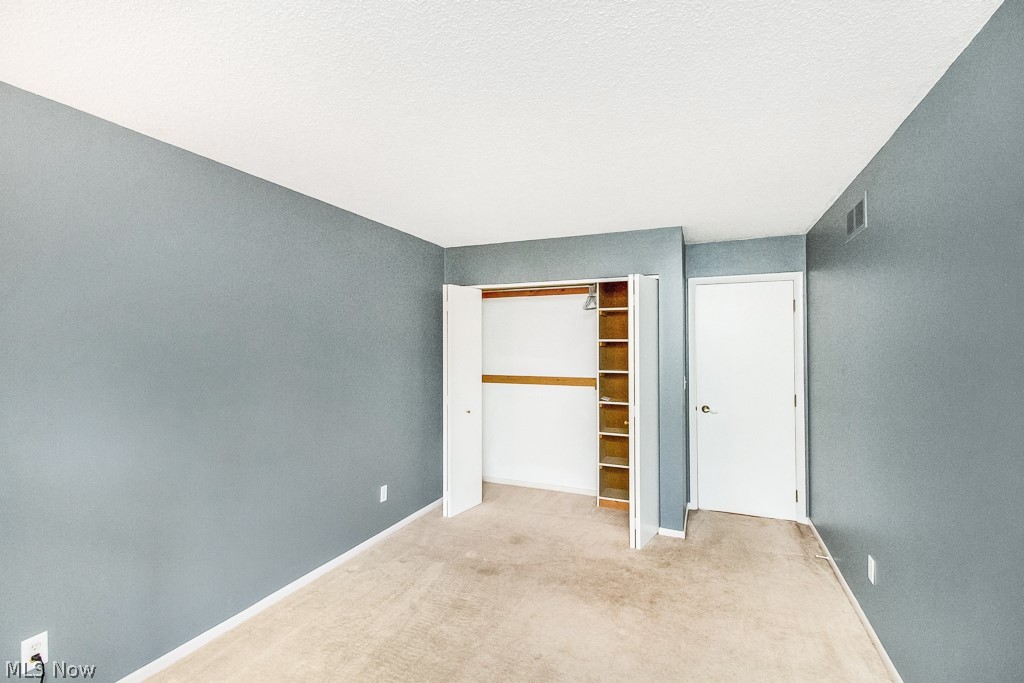 452 Hampton Ridge Drive Akron, OH 44313 - Photo 17 of 25 A large closet with built in storage can be found in the guest room.