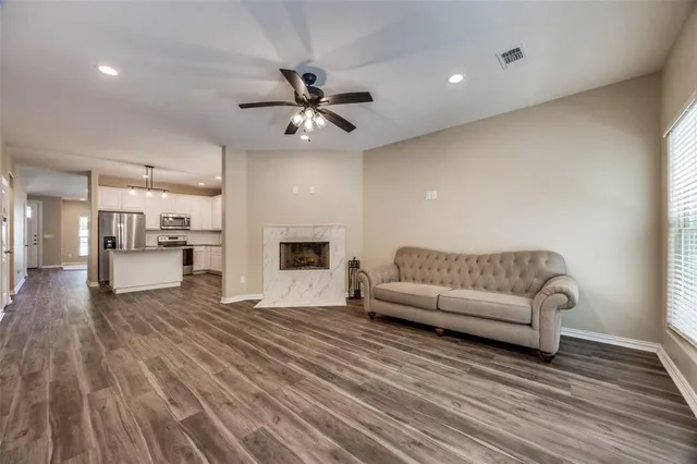 a living room with furniture and a wooden floor