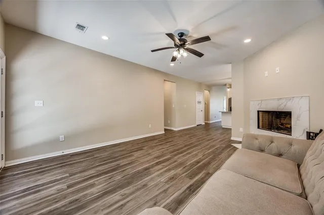 a living room with furniture and a ceiling fan