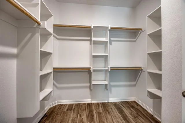 a view of walk in closet with empty racks