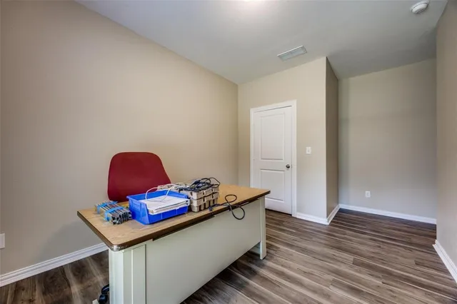 a living room with hard wood floors and a wooden floor