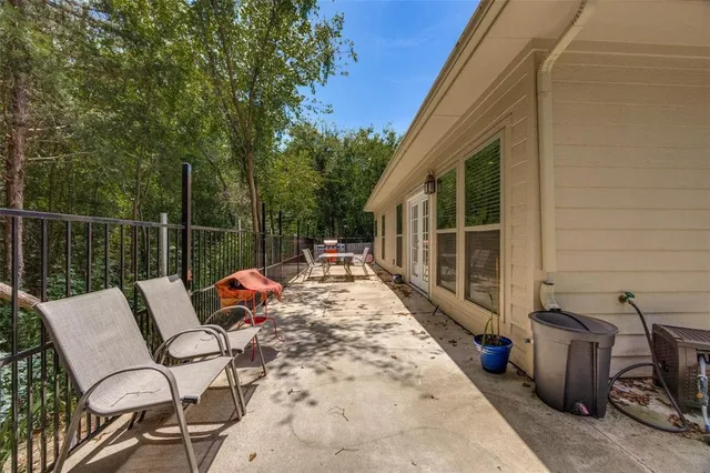 a view of a patio with a table chairs and a potted plant