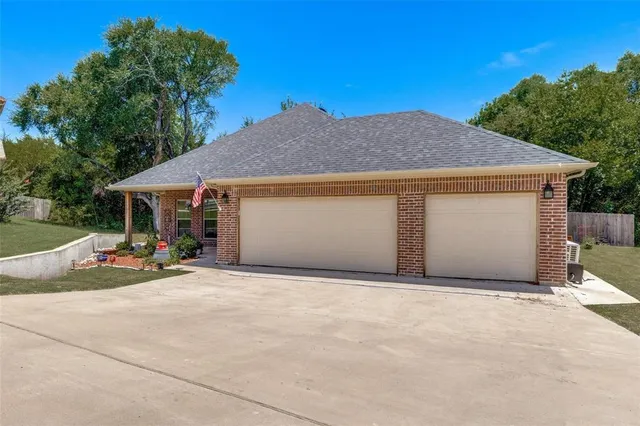 a view of a house with a garage and yard