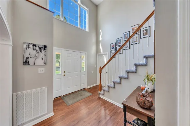a view of entryway and hall with wooden floor