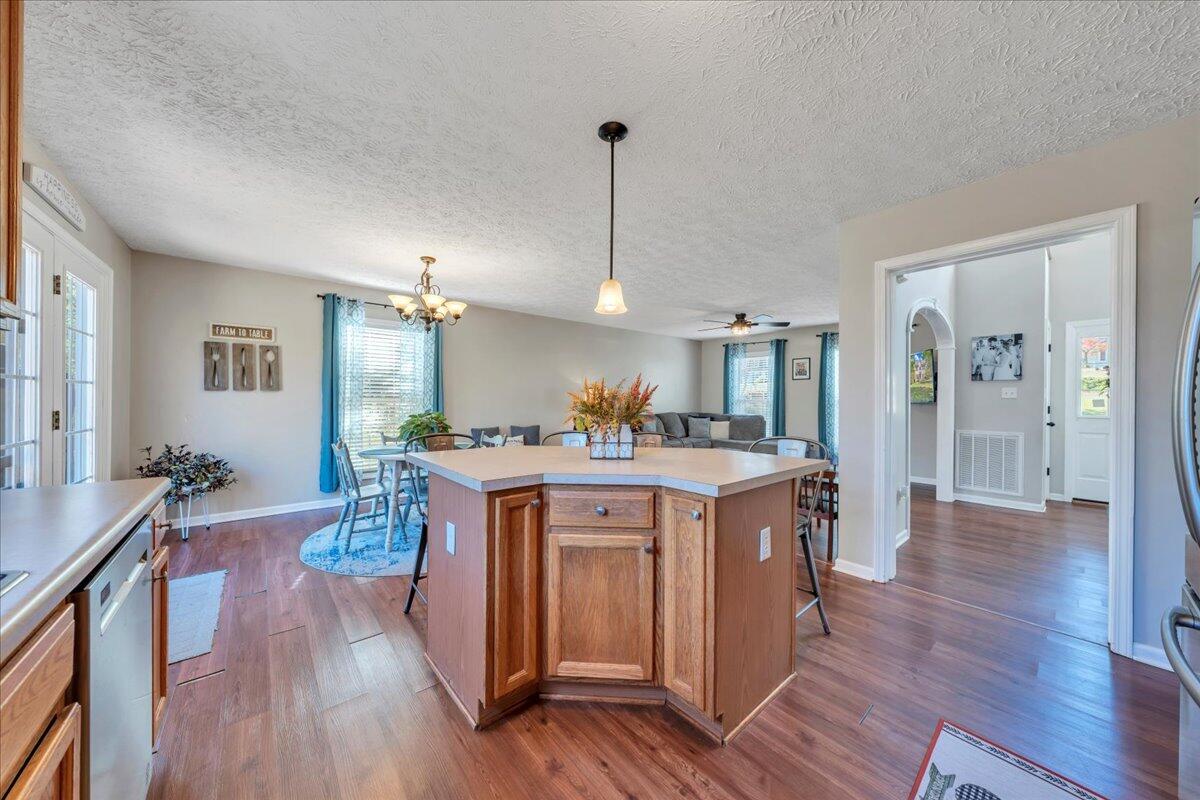 780 Farmington Road Hardy, VA 24101 - Photo 17 of 50 a large kitchen with stainless steel appliances granite countertop a stove a sink dishwasher and a dining table with wooden floor