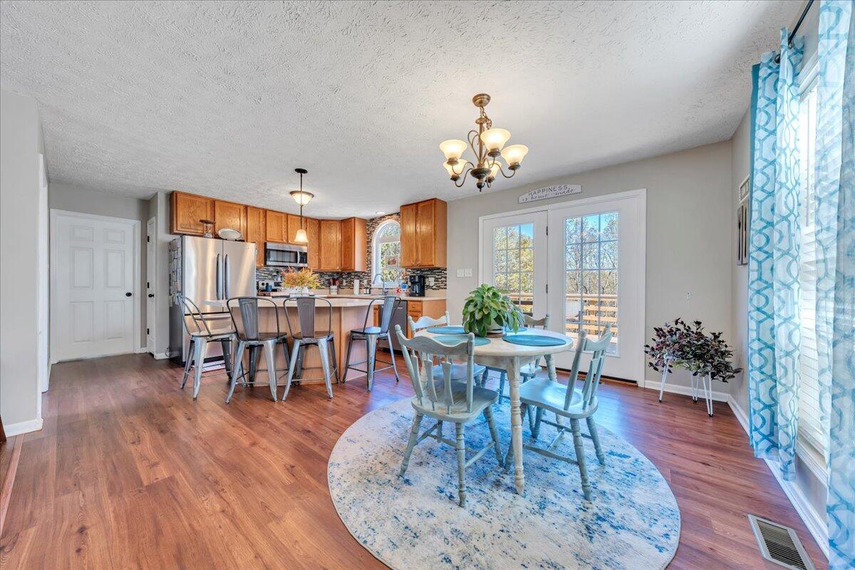 780 Farmington Road Hardy, VA 24101 - Photo 18 of 50 a view of a dining room with furniture and wooden floor
