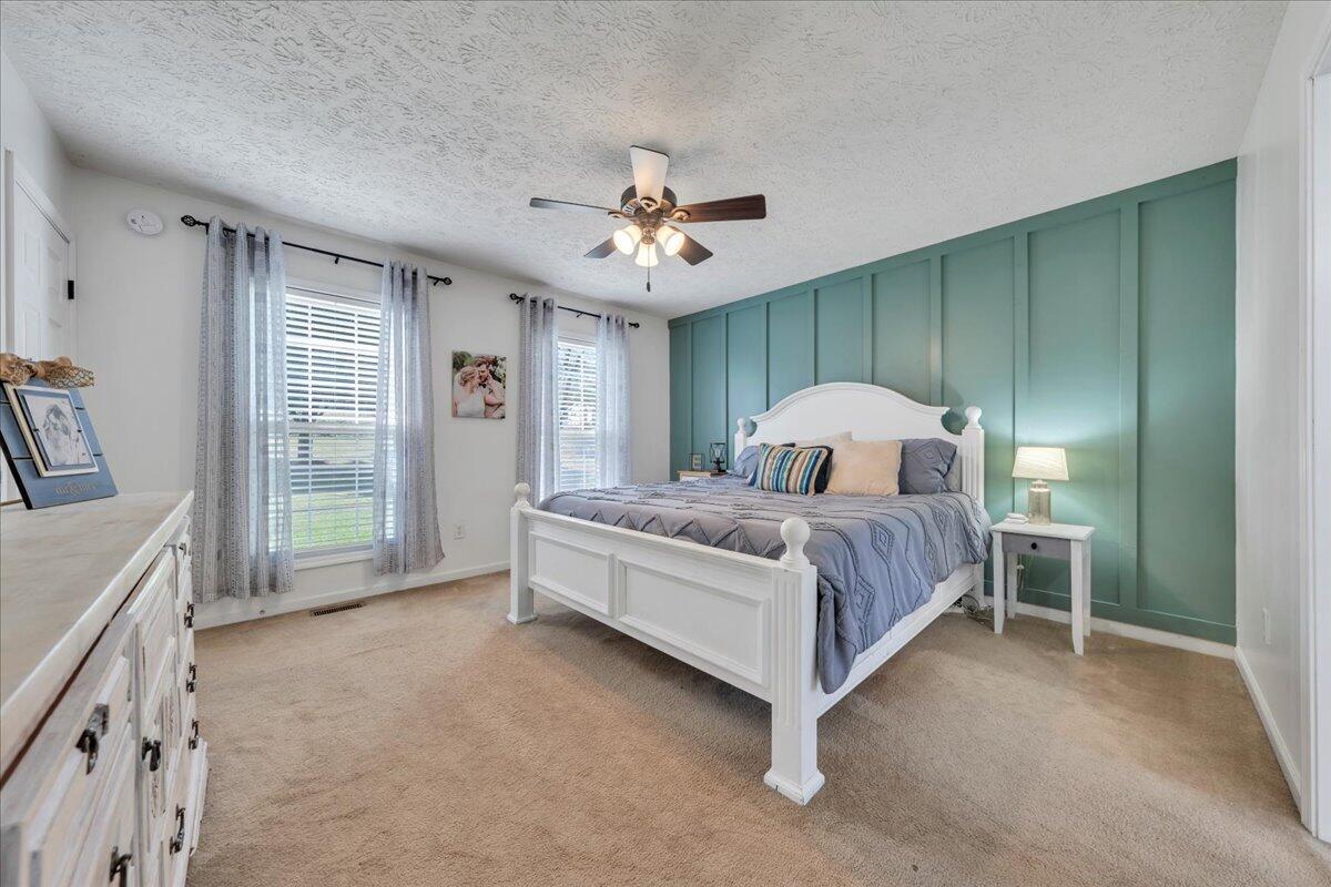 780 Farmington Road Hardy, VA 24101 - Photo 21 of 50 a spacious bedroom with a bed and a chandelier