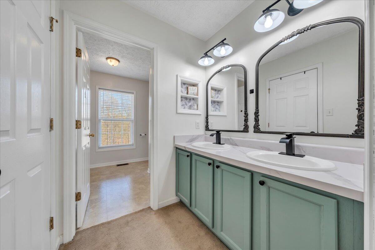 780 Farmington Road Hardy, VA 24101 - Photo 22 of 50 a bathroom with a double vanity sink and a mirror