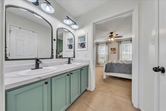 a en suite bathroom with a double vanity sink and a mirror