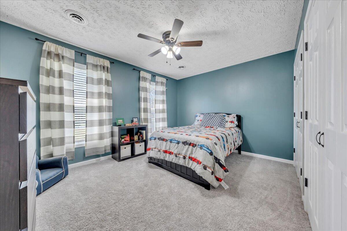 780 Farmington Road Hardy, VA 24101 - Photo 32 of 50 a bedroom with a bed and a chandelier