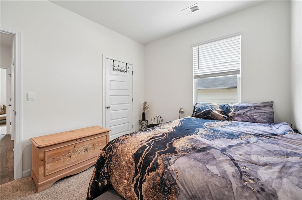 8592 Seabiscuit Road Lithonia, GA 30058 - Photo 14 of 25 a bedroom with a bed and a window