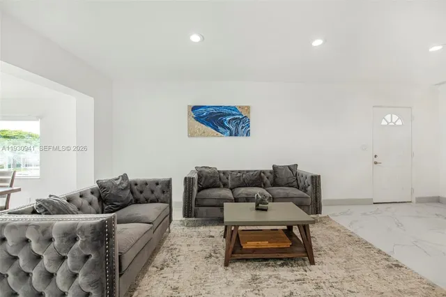 a living room with furniture and a rug