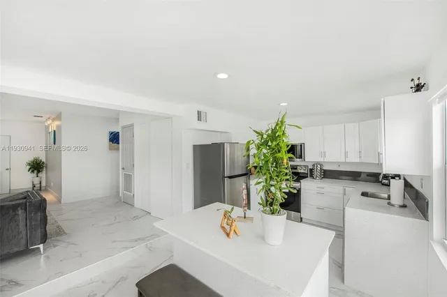 a kitchen with a table and chairs