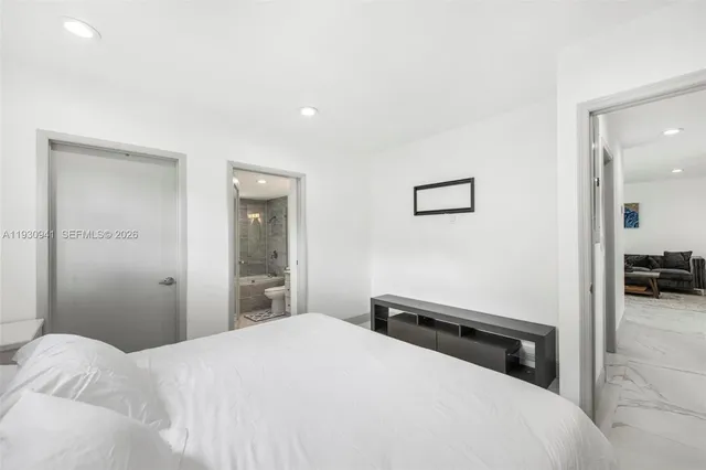 a bedroom with a bed and a view of bedroom