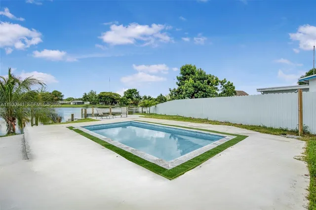 a view of swimming pool with a yard