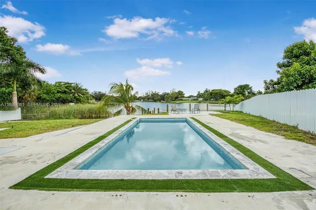 a view of swimming pool with a yard