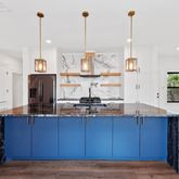 a view of kitchen with granite countertop stainless steel appliances and a wooden floor