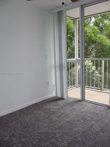 a view of empty room with floor to ceiling windows