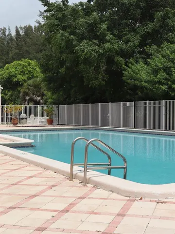 a view of swimming pool with a yard
