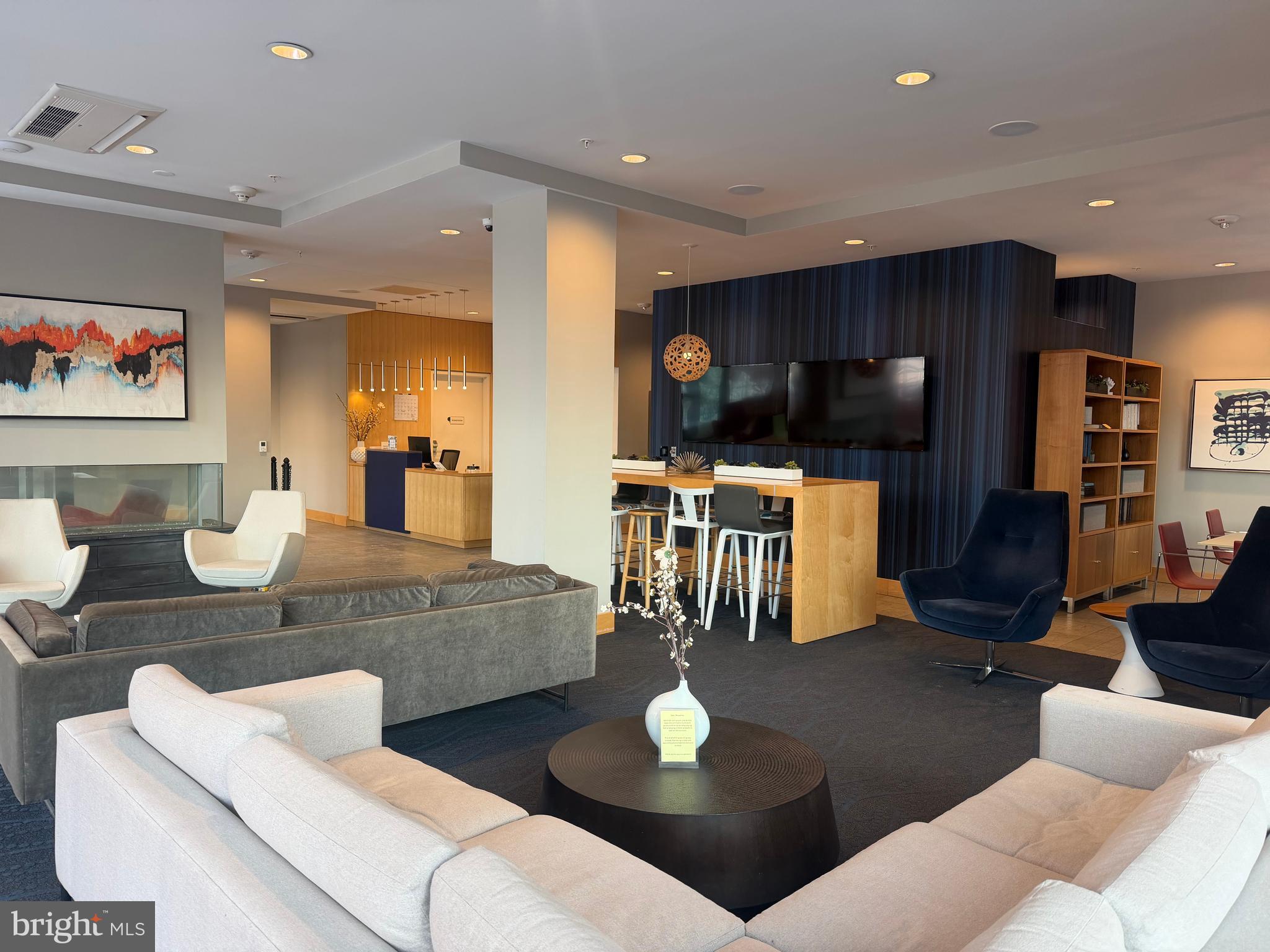 a living room with furniture and kitchen view