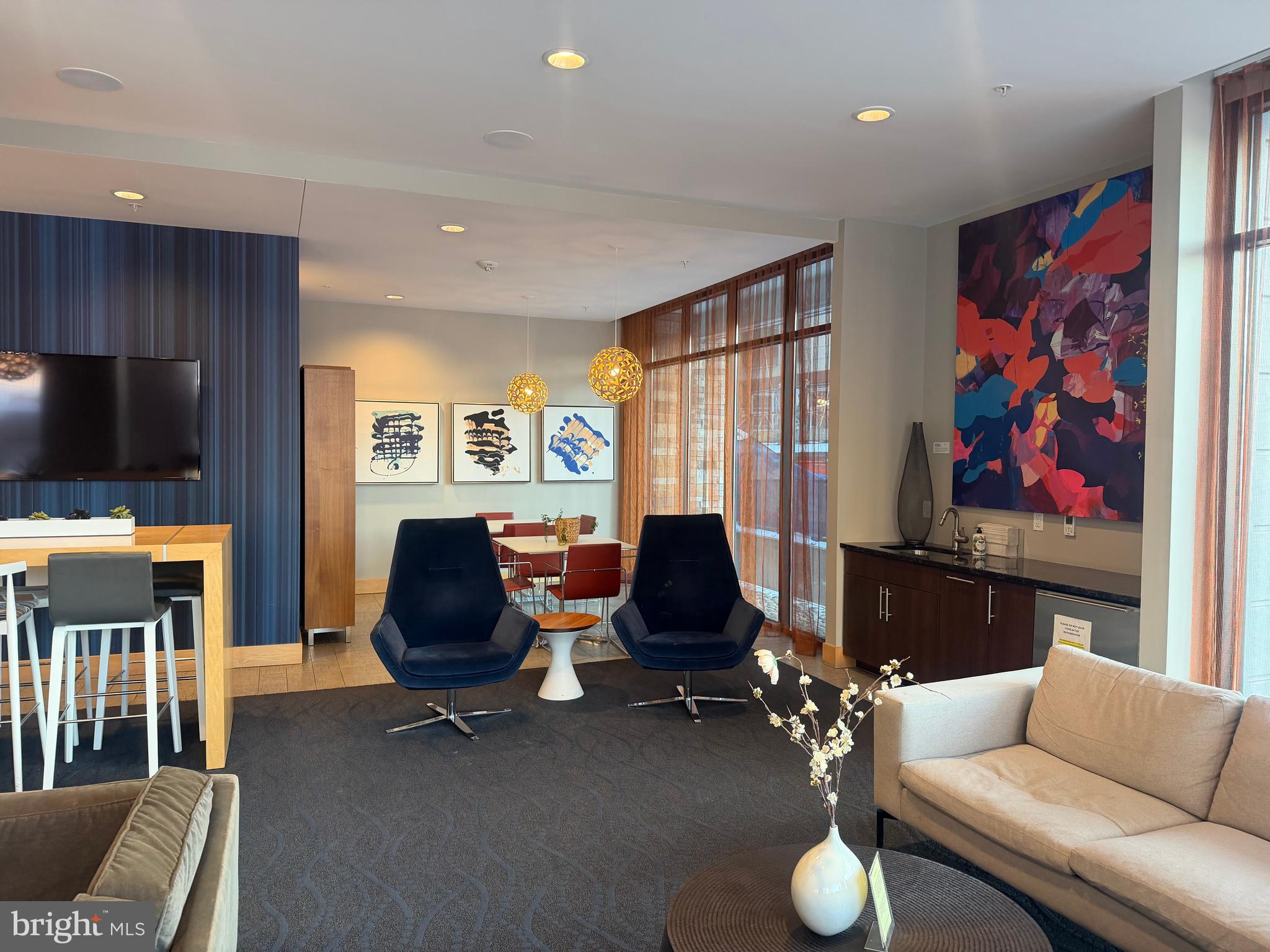 1320 Fenwick Lane, Unit 700 Silver Spring, MD 20910 - Photo 3 of 25 a living room with furniture a flat screen tv and a window