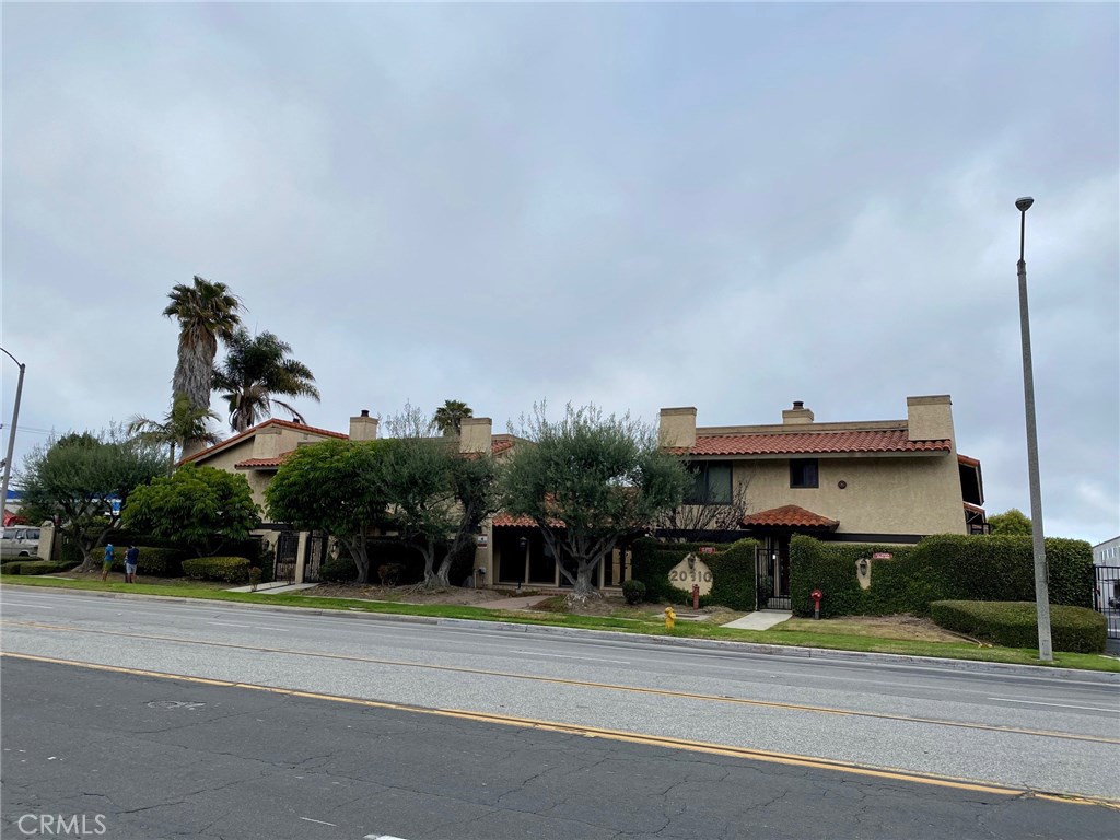 20310 Anza Avenue, Unit R Torrance, CA 90503 - Photo 2 of 54 a front view of a house with a garden and plants