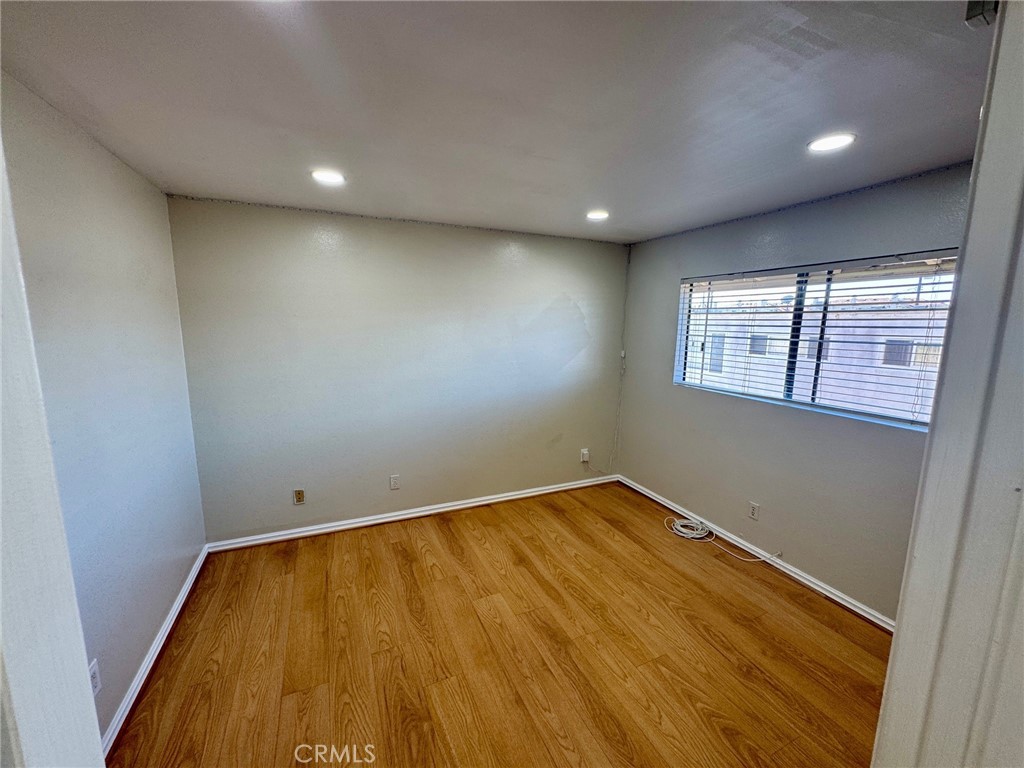 20310 Anza Avenue, Unit R Torrance, CA 90503 - Photo 40 of 54 an empty room with wooden floor and windows