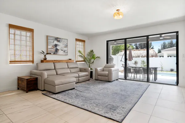 a living room with furniture and a large window with outer view