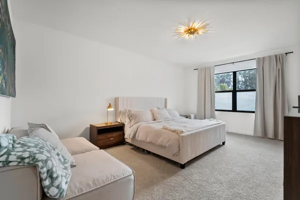 a bedroom with two beds and a chandelier