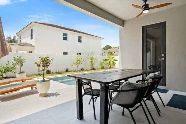 a view of a dining table and chairs in the patio