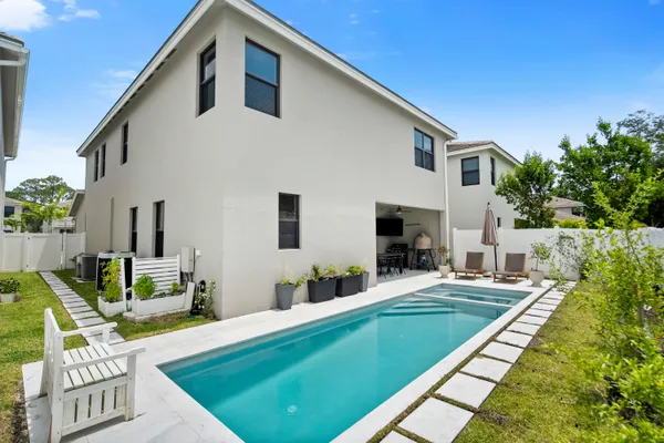 a view of an house with backyard and furniture