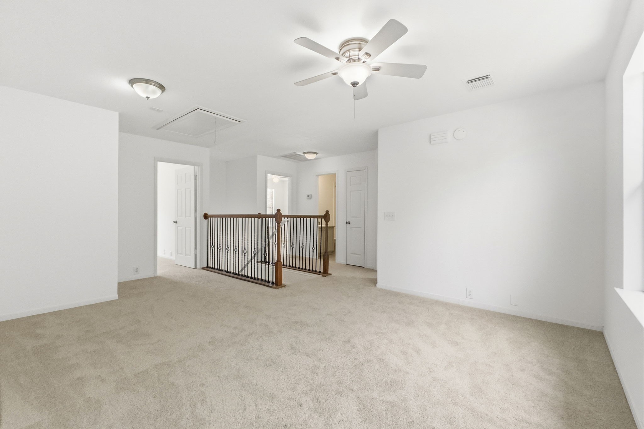 11907 Ezekiel Road Tomball, TX 77375 - Photo 22 of 39 an empty room with chandelier fan and windows