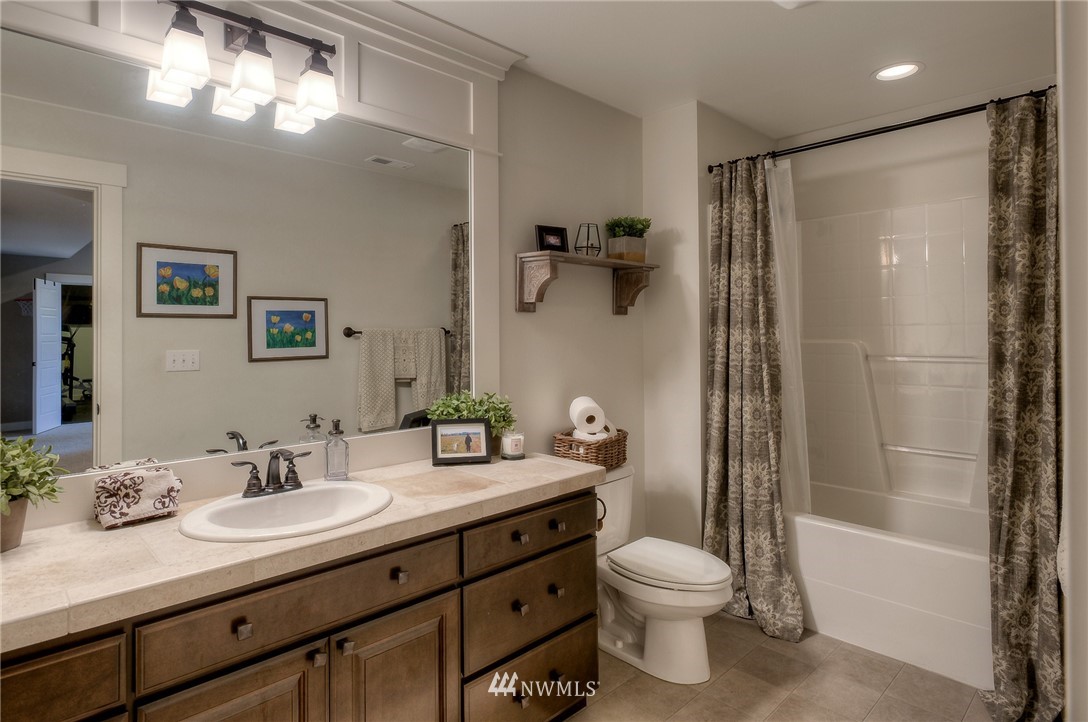22008 43rd Drive Southeast Bothell, WA 98021 - Photo 22 of 25 a bathroom with a granite countertop sink toilet and shower