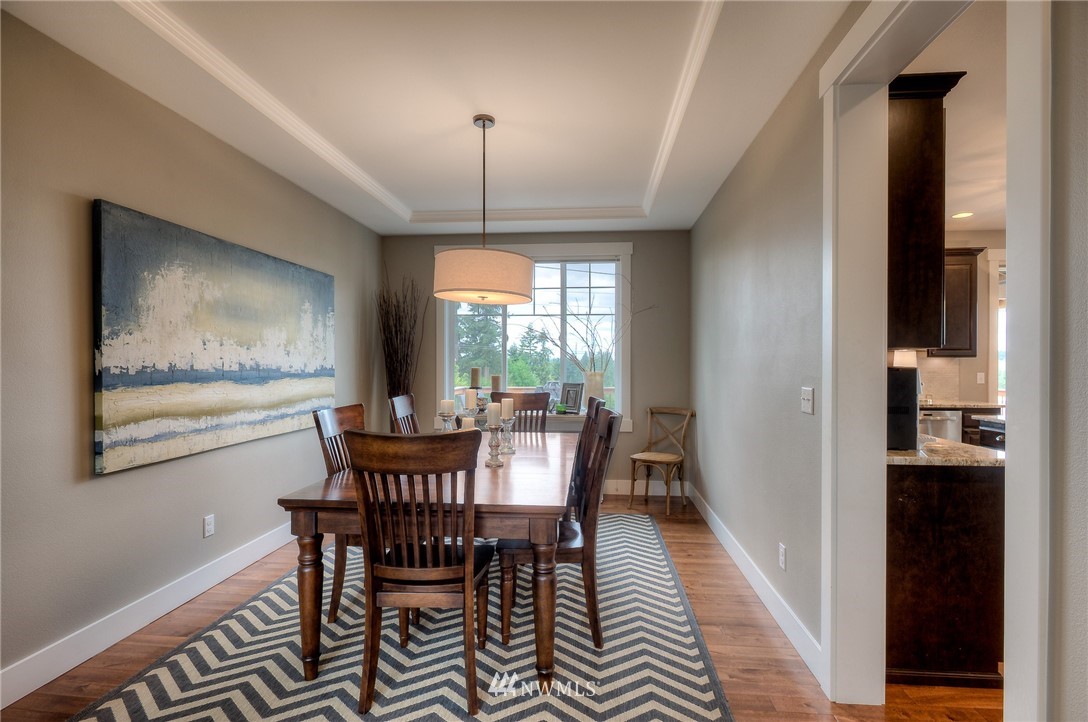 22008 43rd Drive Southeast Bothell, WA 98021 - Photo 4 of 25 a view of a dining room with furniture window and wooden floor