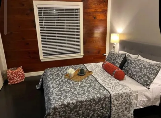 a bedroom with a bed and a window