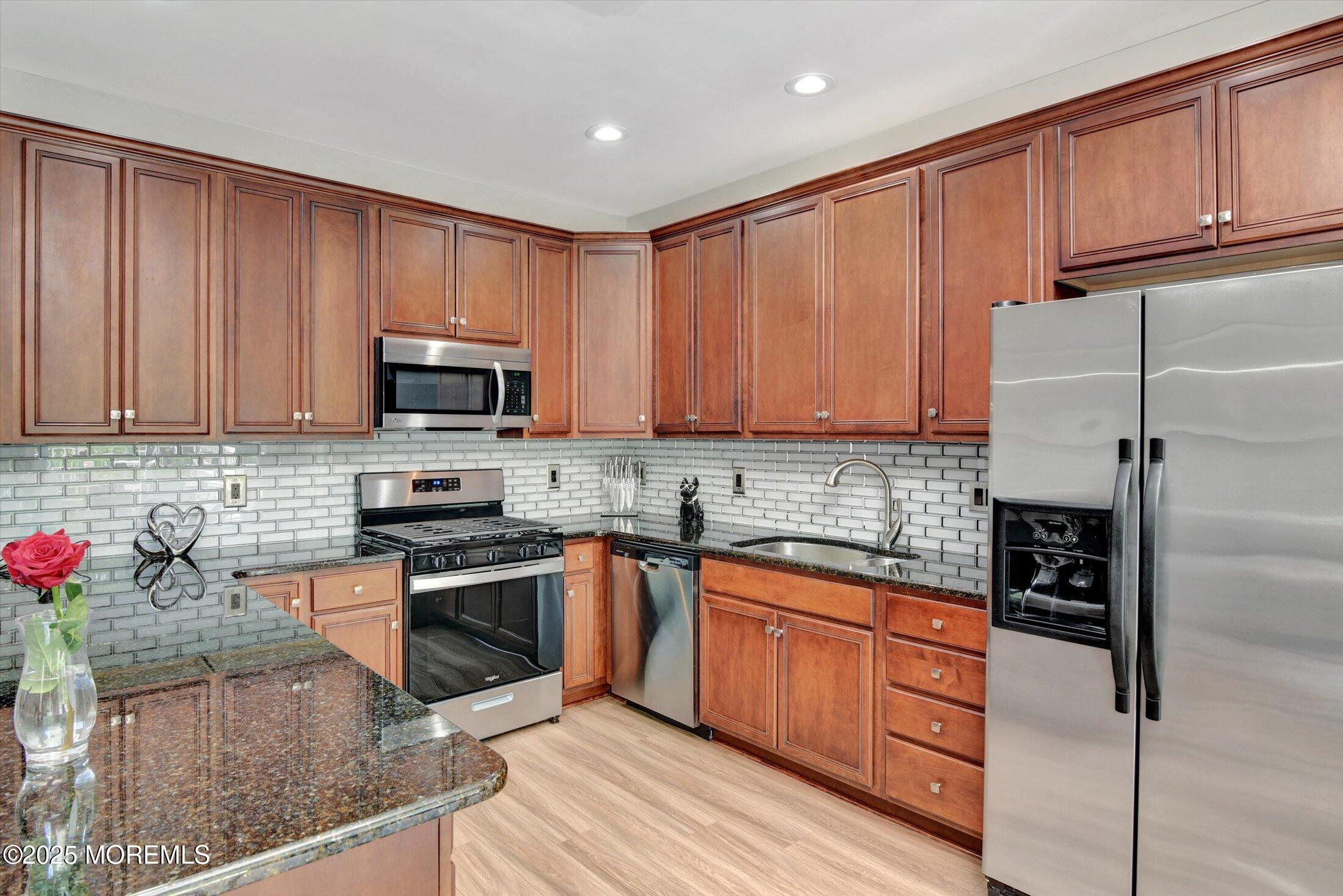45 Brookfield Drive Jackson, NJ 08527 - Photo 17 of 39 a kitchen with stainless steel appliances granite countertop a refrigerator sink and cabinets
