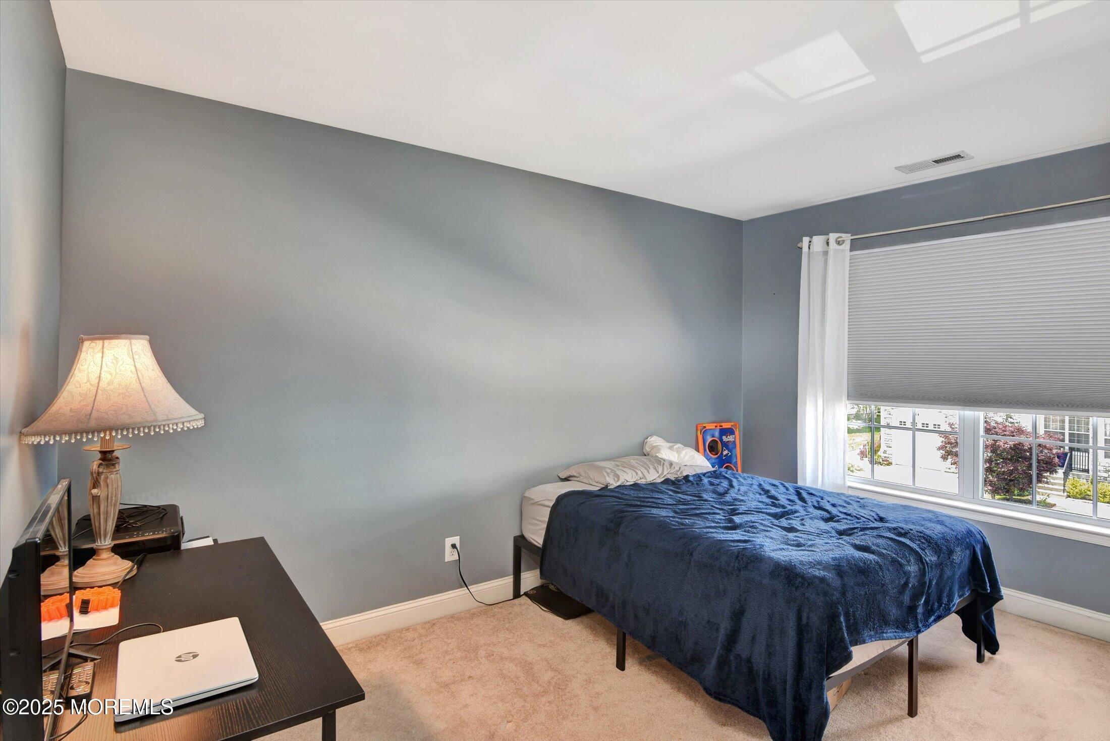 45 Brookfield Drive Jackson, NJ 08527 - Photo 22 of 39 a bedroom with a bed and a lamp