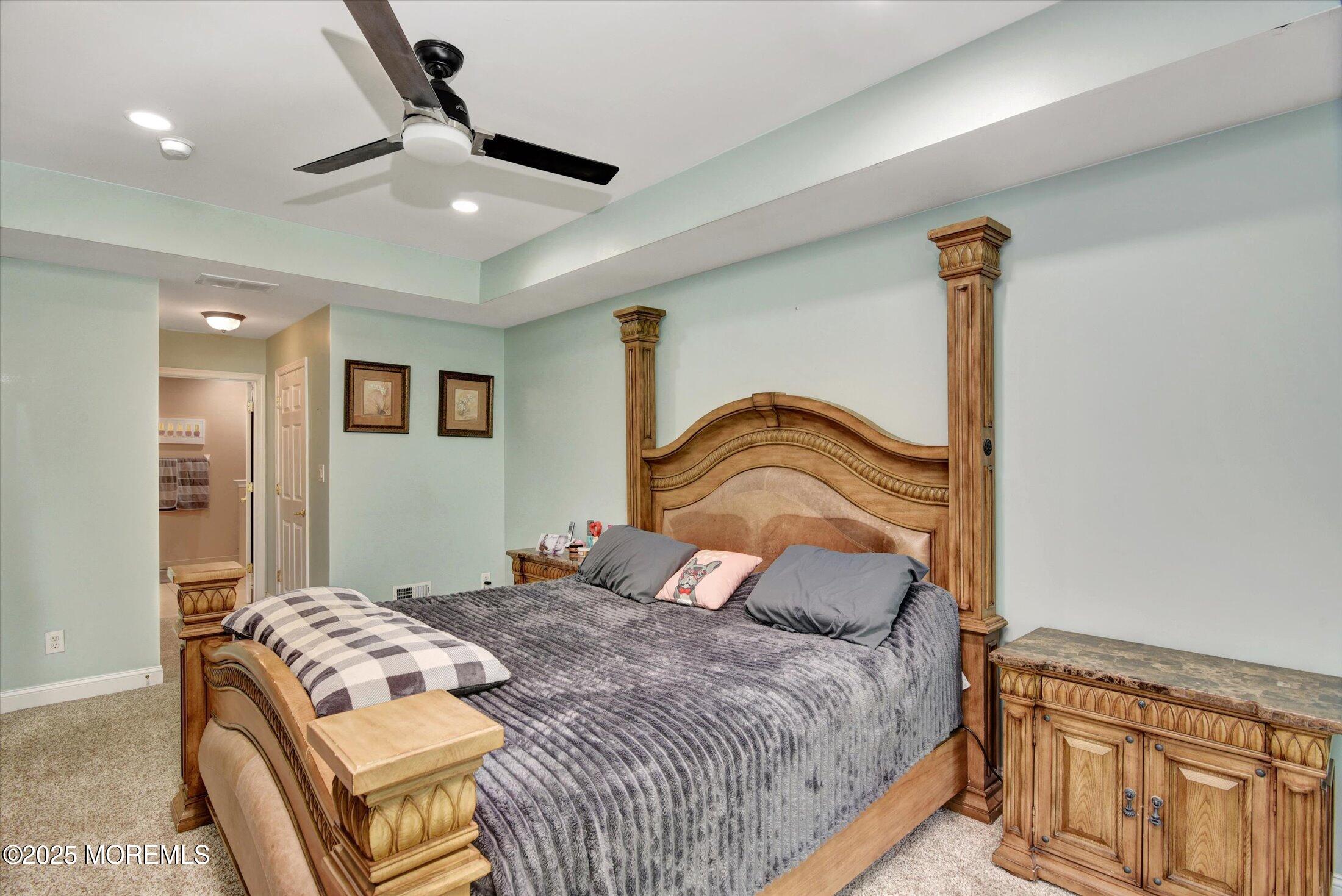 45 Brookfield Drive Jackson, NJ 08527 - Photo 27 of 39 a bedroom with a bed ceiling fan and a wooden floor