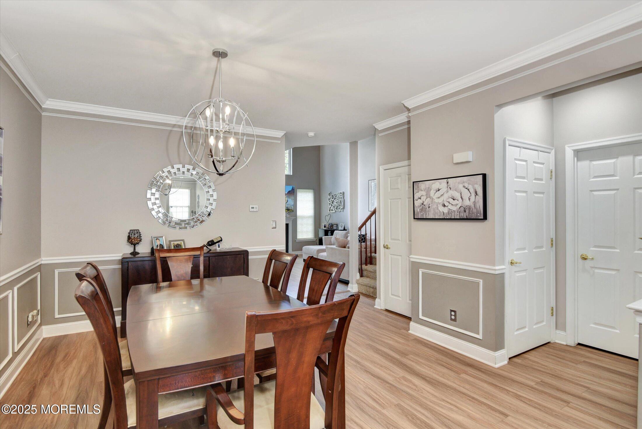 45 Brookfield Drive Jackson, NJ 08527 - Photo 9 of 39 a view of a dining room with furniture a chandelier and wooden floor