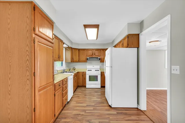 a kitchen with a refrigerator a stove top oven a washer and dishwasher