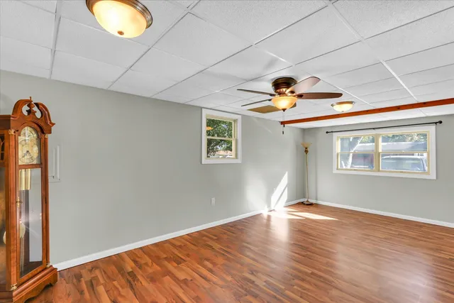 a view of empty room with wooden floor