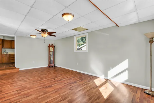 a view of empty room with wooden floor
